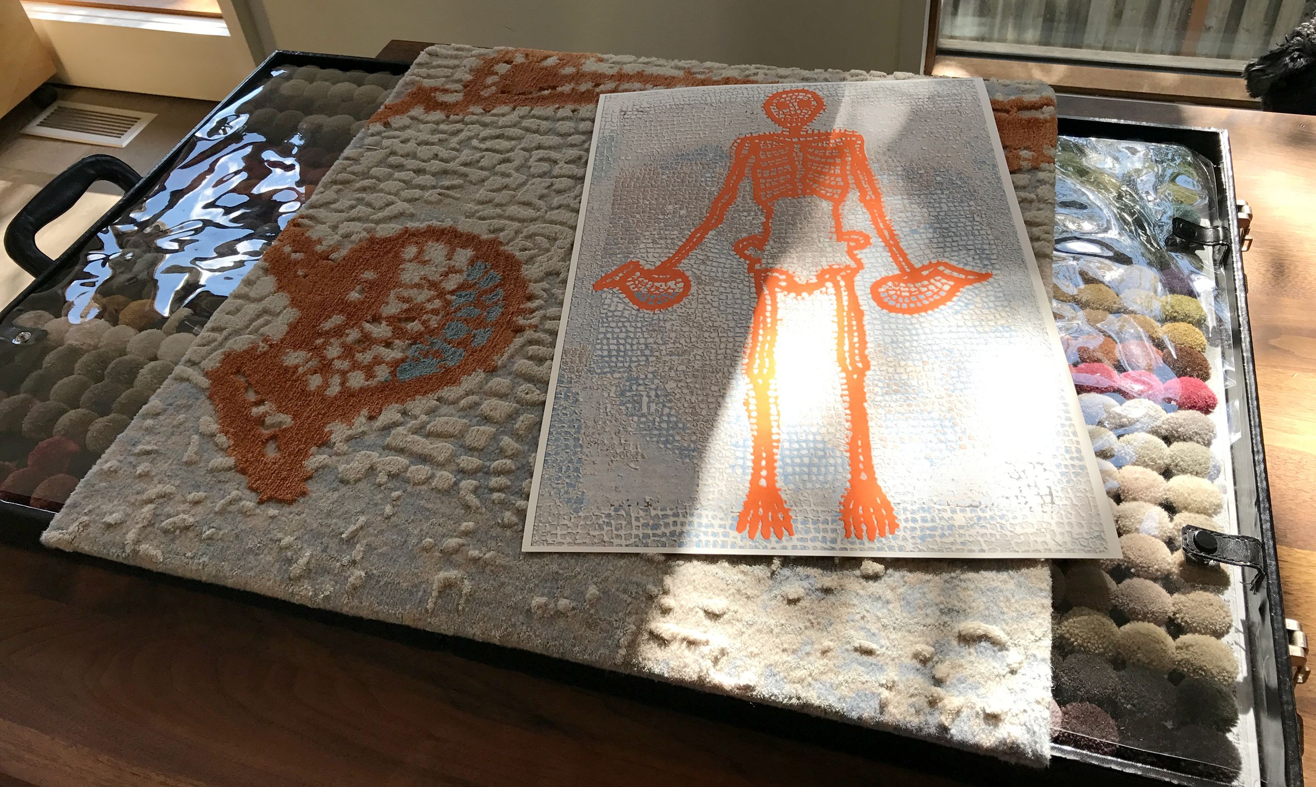 Custom carpet samples, coloured "poms" used in choosing colours and printed design based on a mosaic from Pompei.