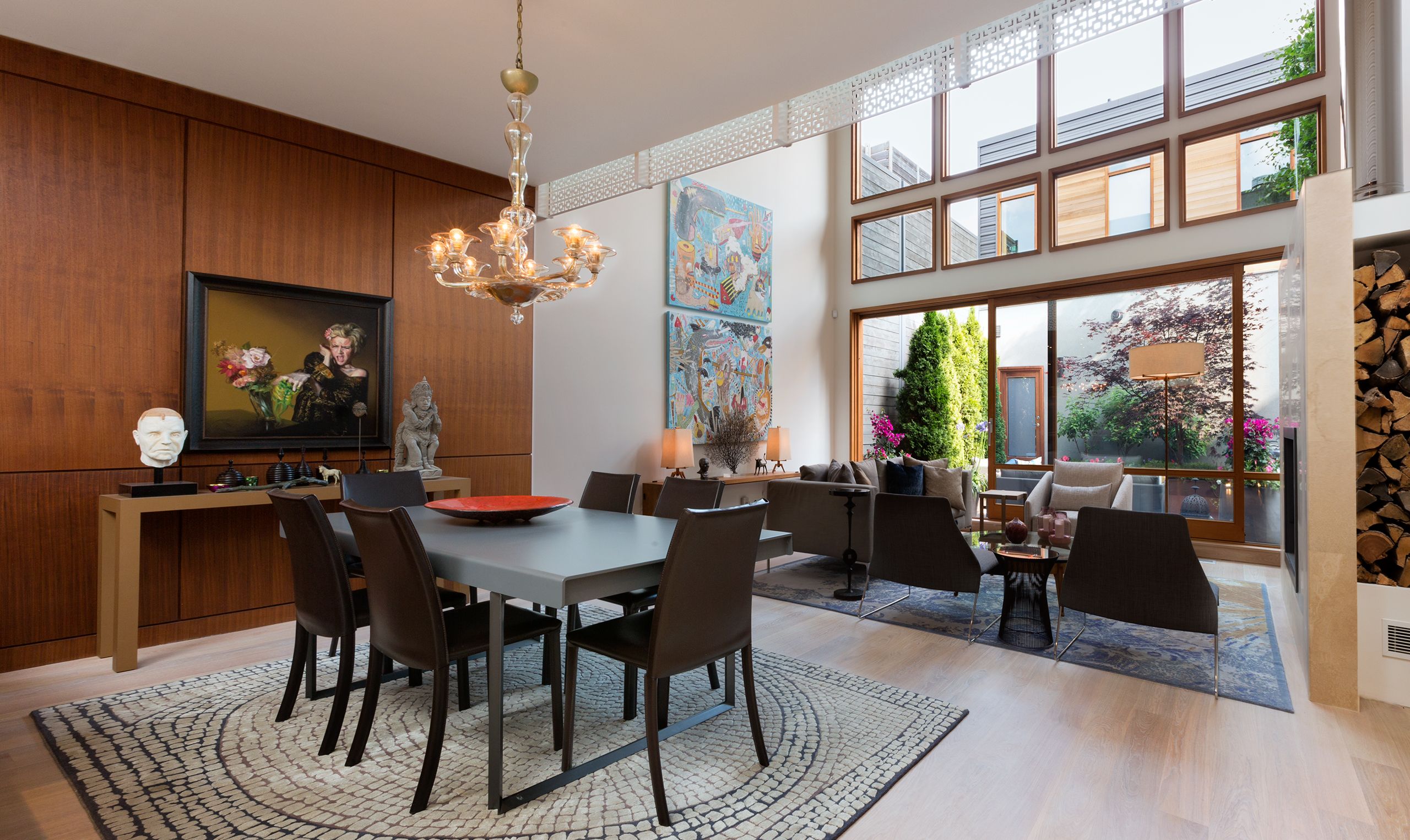 View into the Living area, window wall and garden. The Murano glass chandelier is vintage.