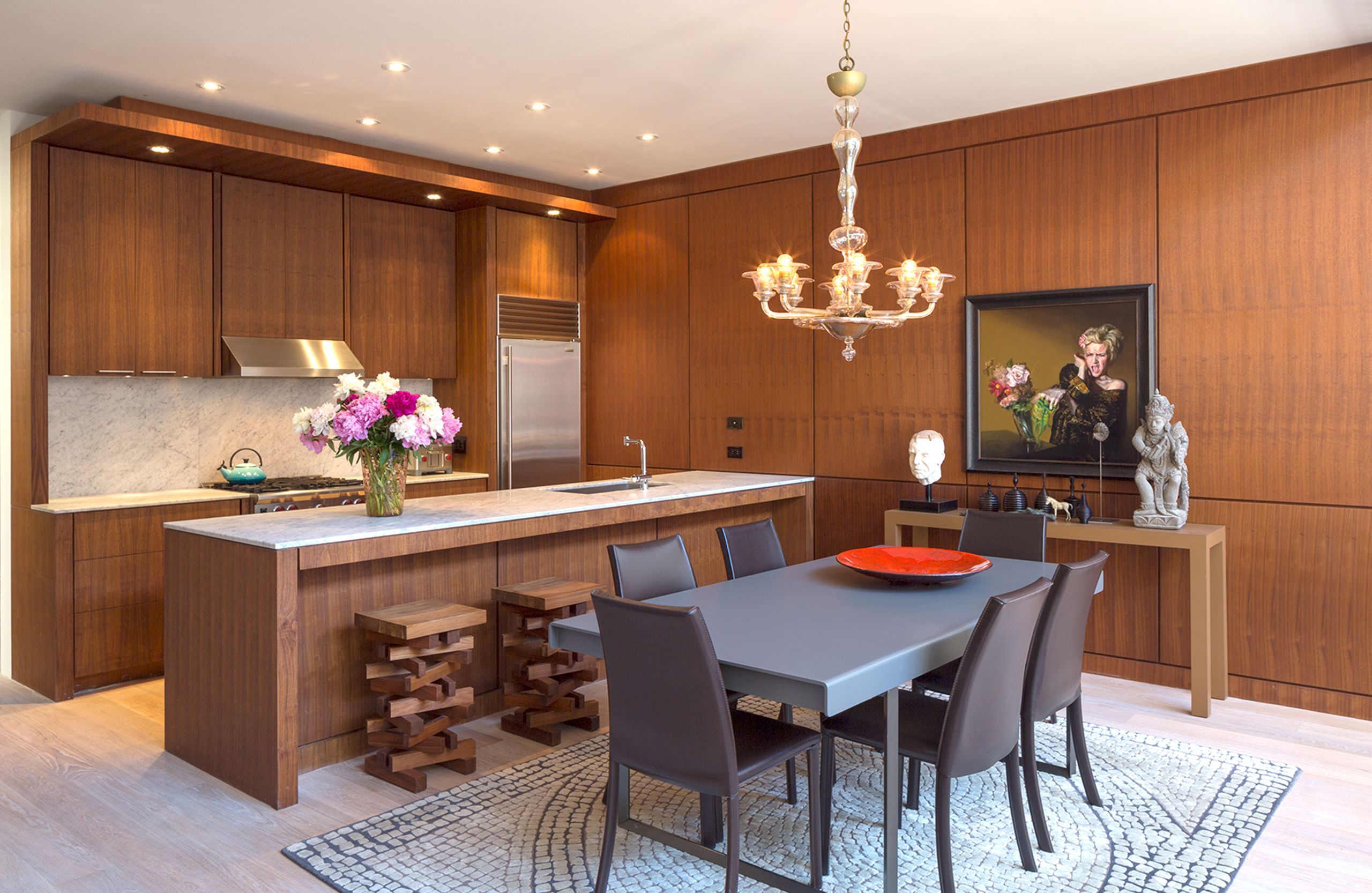 Walnut Kitchen with Carrera marble counters and backsplash, Wolf stove and Sub-Zero fridge.