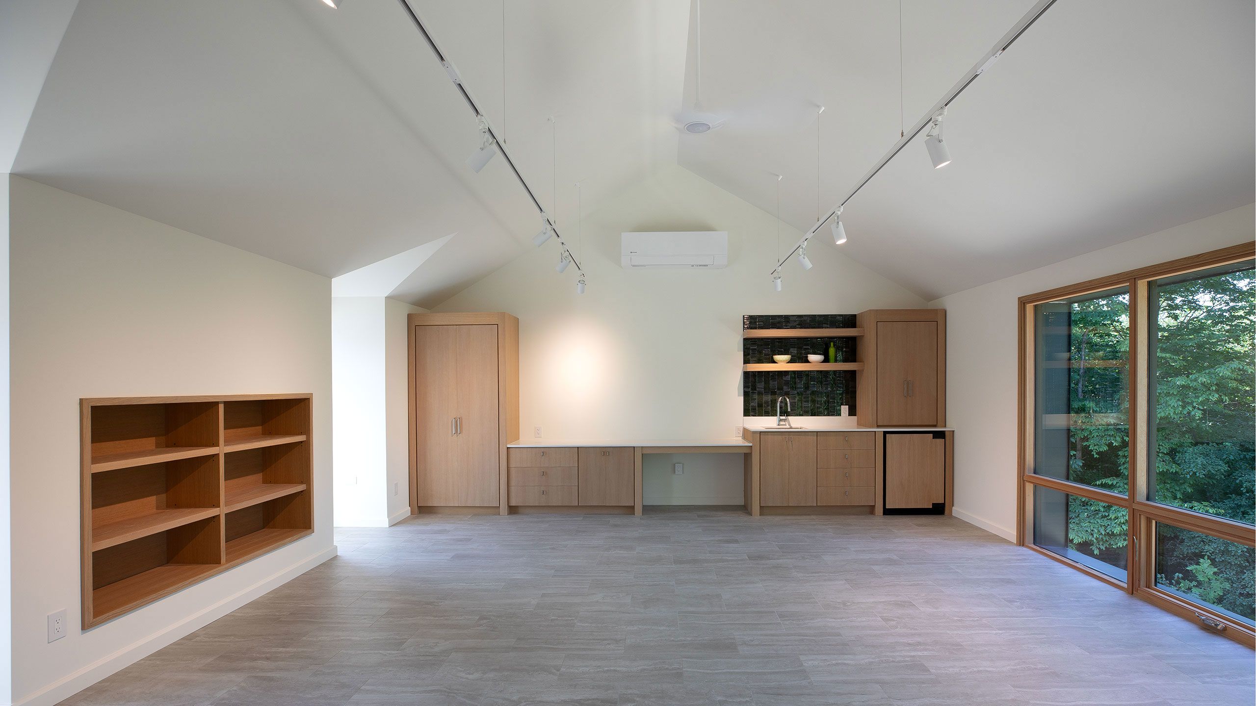 Another view of dormer windows, kitchen and built-in bookcase.